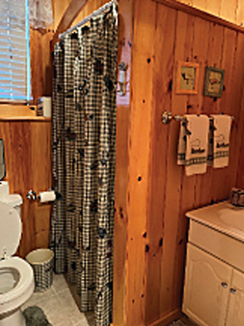 A bathroom with shower is conveniently located.