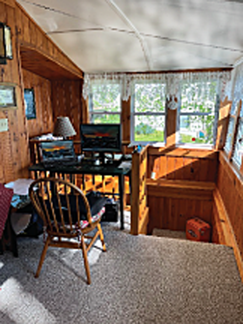 Enjoy wonderful natural lighting in cozy pine paneled nooks at this quaint vacation shorefront cottage.
