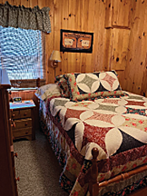 This vacation cottages also includes cozy bedrooms complete with quilts and sham pillows.