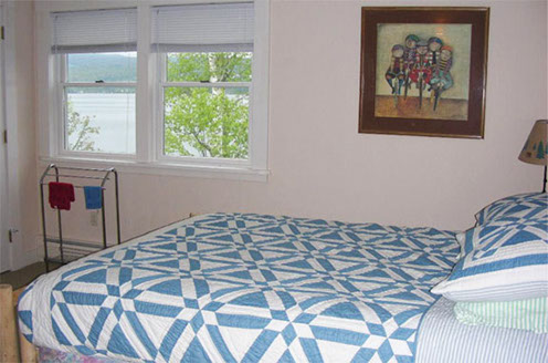 Contemporary, comfortable, bedrooms accompany this pristine lakefront vacation home. 