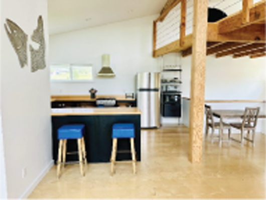 A spacious open floor plan combining kitchen and living area add to the charm of this contemporary vacation home.