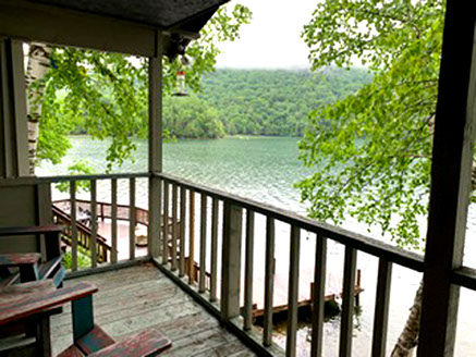 This vacation cottages includes a deck and stairway to the lake.