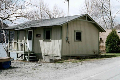 Unpretentious from the front exterior, enjoy this cottage's fabulous location.